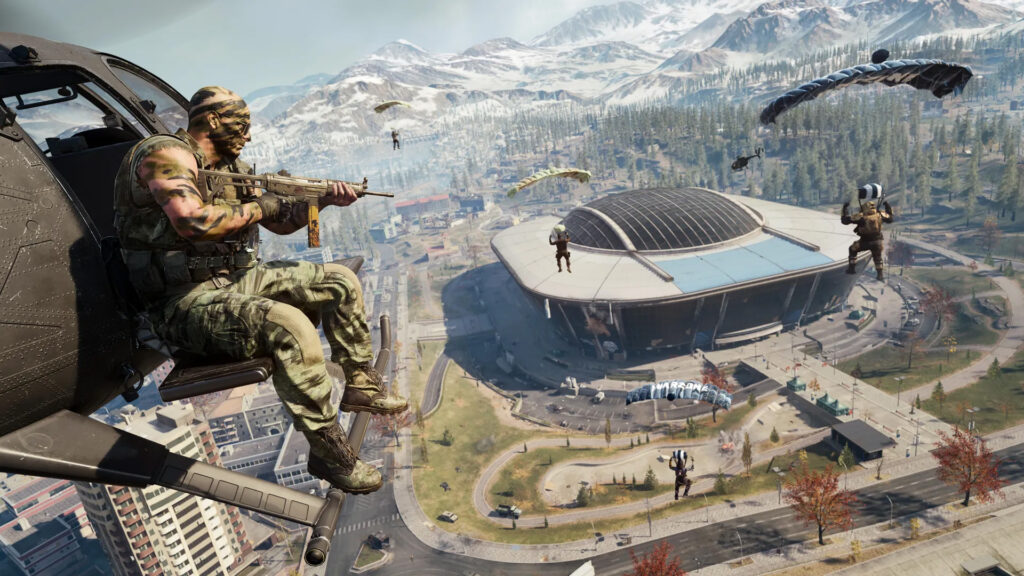 Image of Call of Duty: Warzone players parachuting into Verdansk. The Verdansk stadium with the roof closed is in the background