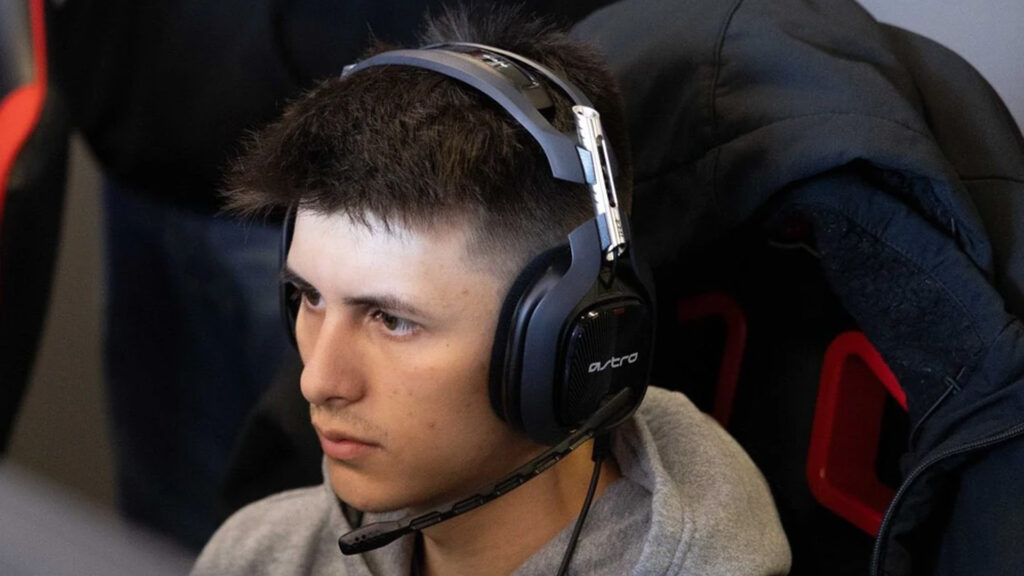 Image of Call of Duty player Encourage sitting on stage while wearing Astro headset